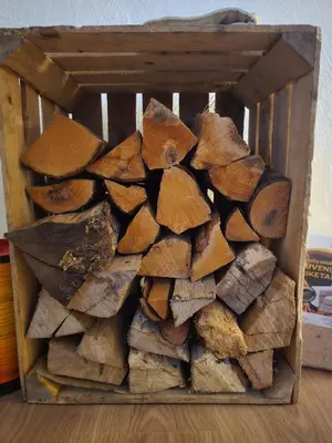 a pile of wood in a wooden box at TRoBA in Vilnius