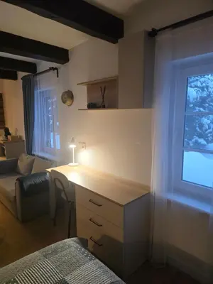 a living room with a desk and a window at TRoBA in Vilnius