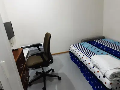 a bedroom with a desk and a chair next to a bed at Frankes Cozy One Bedroom Apartment in Vilnius