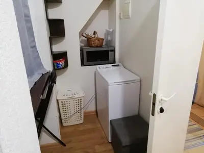 a small kitchen with a refrigerator and a microwave at Frankes Cozy One Bedroom Apartment in Vilnius