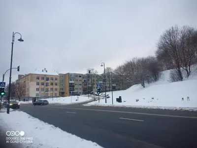 a street with snow on the side of the road at Frankes Cozy One Bedroom Apartment in Vilnius