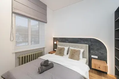 a bedroom with a large bed and a window at Vytauto 43 Residence 9 by Domvia in Kaunas