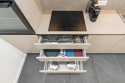 a kitchen counter top with a drawer with tools at Vytauto 43 Residence 9 by Domvia in Kaunas