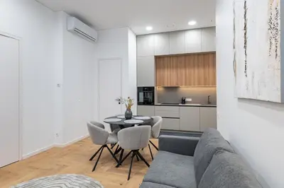 a living room with a couch and a table and chairs at Vytauto 43 Residence 9 by Domvia in Kaunas