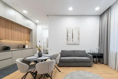 a living room with a couch and a table and chairs at Vytauto 43 Residence 9 by Domvia in Kaunas