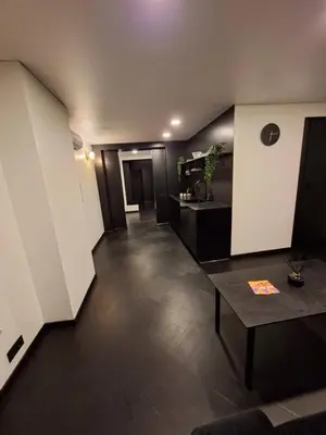 a living room with a table in a room at Kauno buzo namuciai in Kaunas