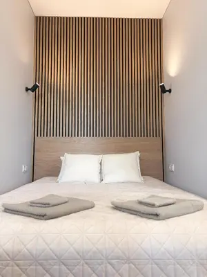 a bedroom with a large bed with two towels on it at Central Svitrigaila Apartments in Vilnius