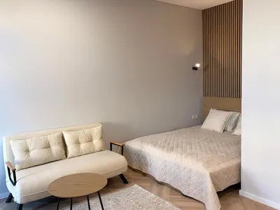 a bedroom with a bed and a couch and a chair at Central Svitrigaila Apartments in Vilnius