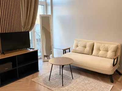 a living room with a couch and a table and a tv at Central Svitrigaila Apartments in Vilnius