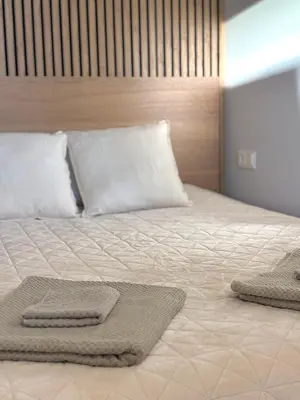 a bed with two towels on top of it at Central Svitrigaila Apartments in Vilnius