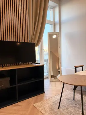 a living room with a tv and a table at Central Svitrigaila Apartments in Vilnius