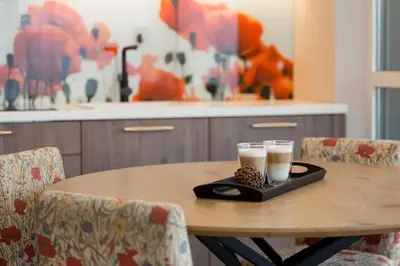 a table with two glasses of milk on a tray at Skyline View Apartment Vilnius in Vilnius