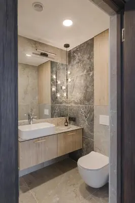 a bathroom with a white toilet and a sink at Skyline View Apartment Vilnius in Vilnius