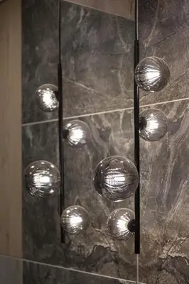 a bunch of lights hanging from a shower at Skyline View Apartment Vilnius in Vilnius