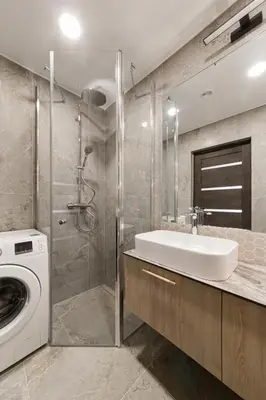 a bathroom with a sink and a washing machine at Skyline View Apartment Vilnius in Vilnius