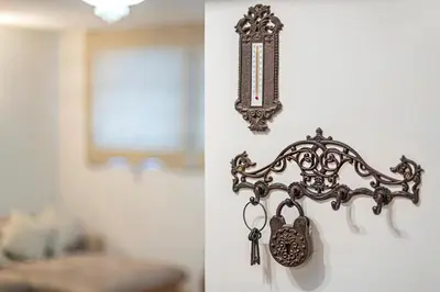 a pair of keys hanging on a wall next to a mirror at Antique apartment by Polo Apartments in Kaunas