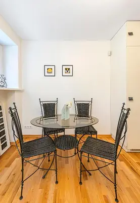a dining room with a glass table and chairs at Antique apartment by Polo Apartments in Kaunas