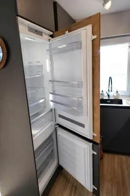 an empty refrigerator with its door open in a kitchen at Klevų 41 Townhouse, Noreikiskes in Kaunas