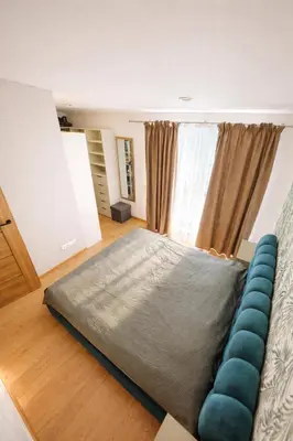 a bedroom with a large bed and a couch at Klevų 41 Townhouse, Noreikiskes in Kaunas