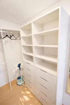 a closet with white shelves in a room at Klevų 41 Townhouse, Noreikiskes in Kaunas