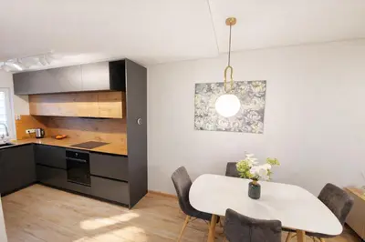 a kitchen and dining room with a white table and chairs at Klevų 41 Townhouse, Noreikiskes in Kaunas