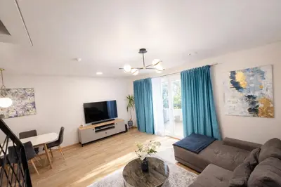 a living room with a couch and a tv at Klevų 41 Townhouse, Noreikiskes in Kaunas