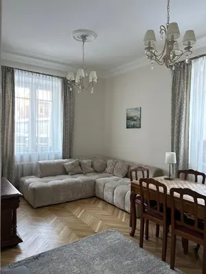 a living room with a couch and a table at City Park Apartment in Vilnius