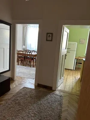an open door to a kitchen and a living room at City Park Apartment in Vilnius