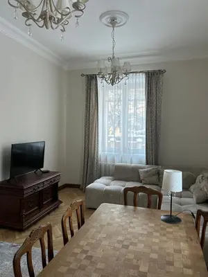 a living room with a table and a couch at City Park Apartment in Vilnius