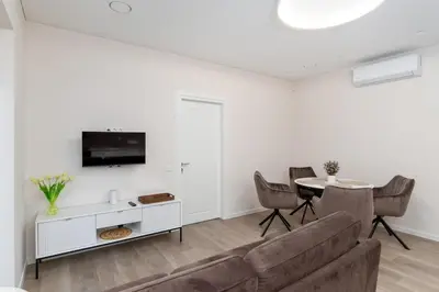 a living room with a couch and a table at Modern Apartment next to Kaunas Clinics in Kaunas