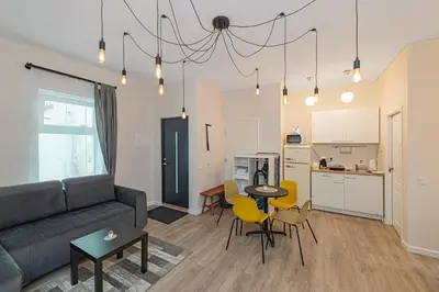 a living room with a couch and a table at Studio apartment Delight by Polo Apartments in Kaunas