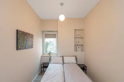a bedroom with a bed and a window at Studio apartment Delight by Polo Apartments in Kaunas