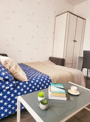 a room with a bed and a table with books at Mocha House 2-Bedroom Apartment Netflix Speedy Wifi in Kaunas