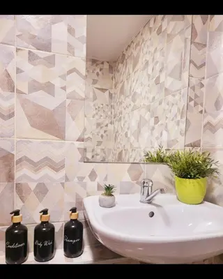 a bathroom with a sink with two bottles on it at Mocha House 2-Bedroom Apartment Netflix Speedy Wifi in Kaunas