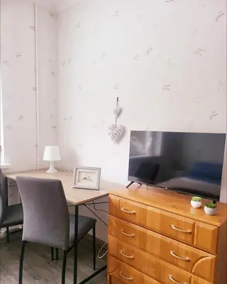 a desk with a television on a wooden dresser at Mocha House 2-Bedroom Apartment Netflix Speedy Wifi in Kaunas