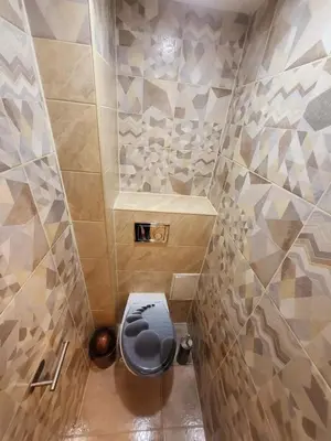 a small bathroom with a toilet in the corner at Mocha House 2-Bedroom Apartment Netflix Speedy Wifi in Kaunas