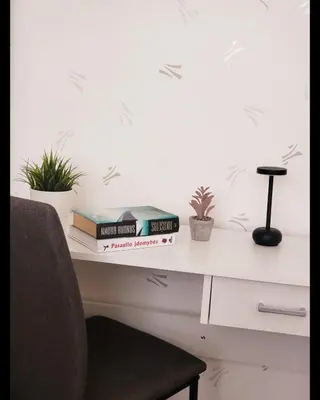 a desk with books and plants on it at Mocha House 2-Bedroom Apartment Netflix Speedy Wifi in Kaunas