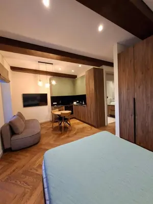 a bedroom with a bed and a couch and a table at Viktor Nemuno house in Kaunas