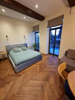 a bedroom with a bed and a table and a couch at Viktor Nemuno house in Kaunas