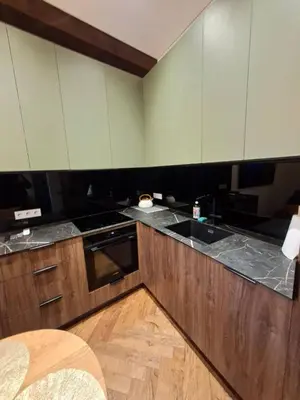a kitchen with wooden cabinets and a sink at Viktor Nemuno house in Kaunas