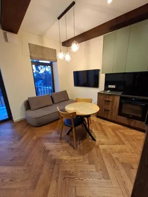 a living room with a table and a couch at Viktor Nemuno house in Kaunas