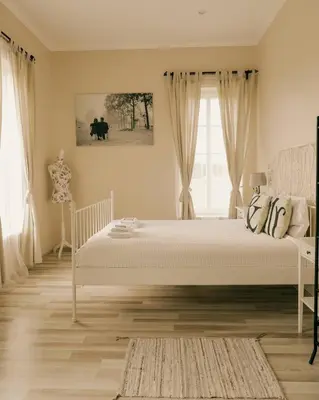 a bedroom with a white bed and a window at Country Stop Room and Shower in Pikeliškės