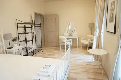 a white room with a dressing table and a mirror at Country Stop Room and Shower in Pikeliškės