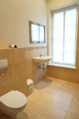 a bathroom with a toilet and a sink and a window at Country Stop Room and Shower in Pikeliškės