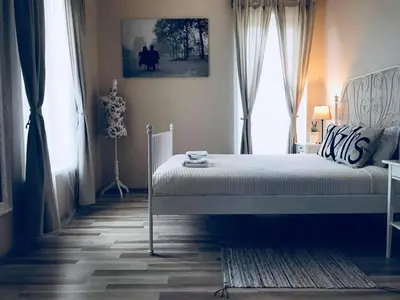 a bedroom with a bed and a window at Country Stop Room and Shower in Pikeliškės