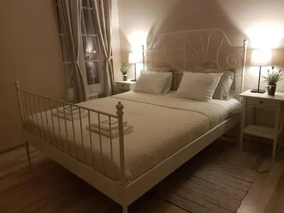 a bedroom with a white bed with white pillows at Country Stop Room and Shower in Pikeliškės