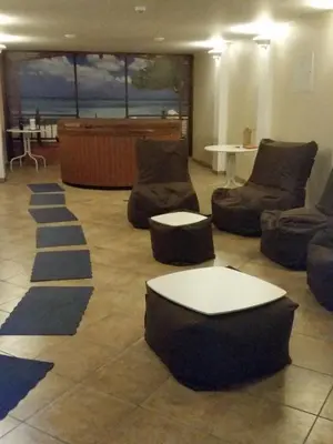 a living room with couches and chairs and a table at Country Stop Room and Shower in Pikeliškės
