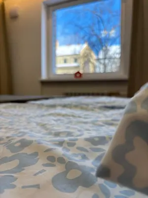 a bedroom with a bed with a window with a view at Exclusive 2 Bedroom Apartment Trendy City Center, Large Terrace & Free Parking in Vilnius