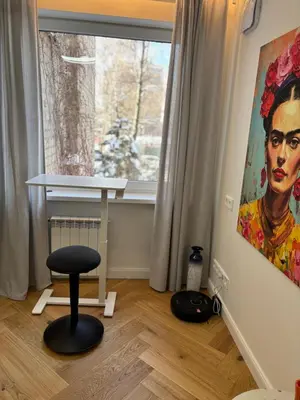 a stool in a room with a painting and a window at Exclusive 2 Bedroom Apartment Trendy City Center, Large Terrace & Free Parking in Vilnius