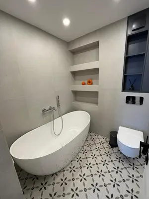 a bathroom with a white tub and a toilet at Exclusive 2 Bedroom Apartment Trendy City Center, Large Terrace & Free Parking in Vilnius